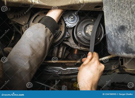 An Auto Mechanic Installs a Alternator Belt in a Passenger Car Engine Stock Image - Image of ...