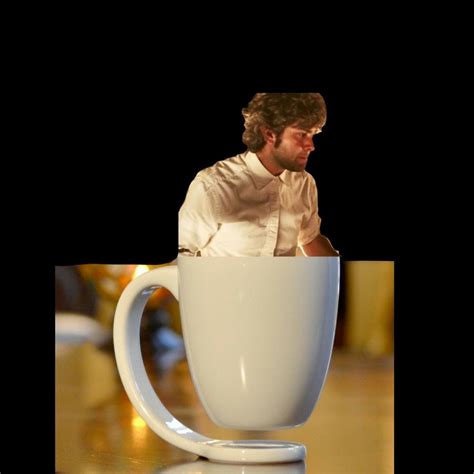 a man is sitting in a coffee cup