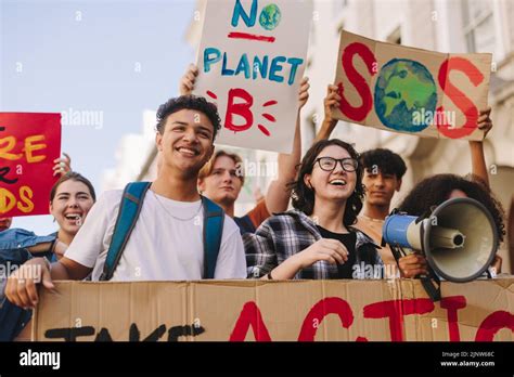 Generation Z environmental activism. Happy young people holding posters and banners while ...