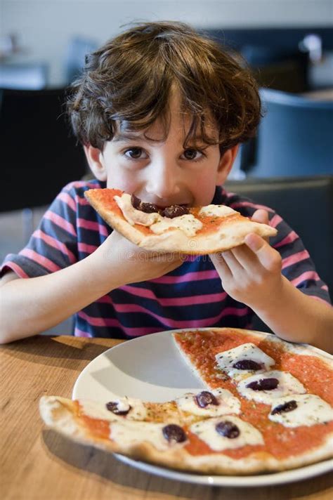 Child eating pizza stock image. Image of cheerful, dining - 14754419