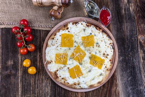 Four Types of Cheese Italian Pizza on a Wooden Floor Stock Photo ...