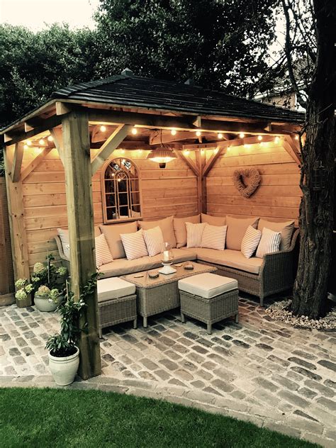 Homemade wooden gazebo, cobbles, garden lights, outdoor sofa, outdoor ...