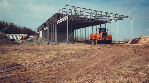 Premium Photo | Construction of a large hangar in the countryside with ...