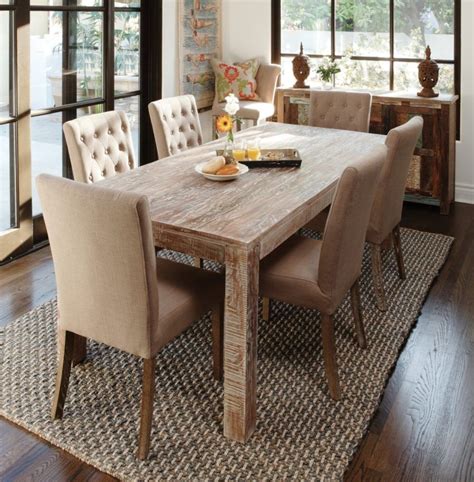 Catchy beige dining room design with natural wooden dining table and tufted backrest beige fab ...