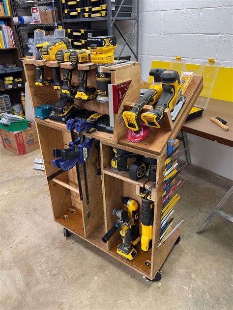 a workbench with tools on it in a room filled with shelves and boxes