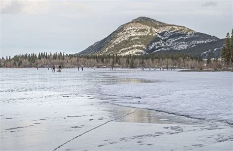 Ice Skating on a Frozen Mountain Lake Stock Image - Image of lake ...