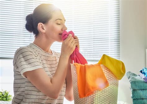 Woman is Smelling Clean Clothes Stock Photo - Image of female, basket: 92760918