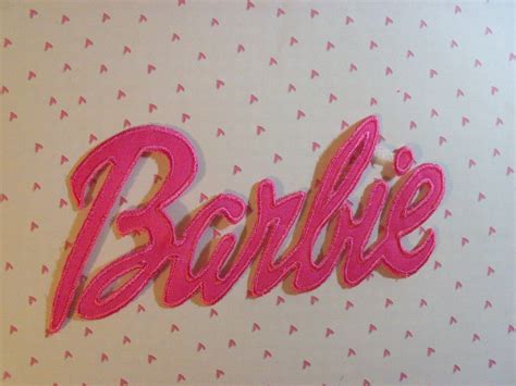 the word barbie written in pink on a white background