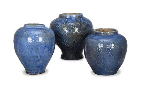 THREE QAJAR BLUE CRACKLE GLAZE AND MOLDED POTTERY JARS,