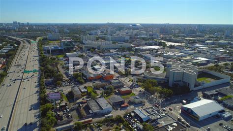 an aerial view of a city with lots of buildings and streets in the foreground