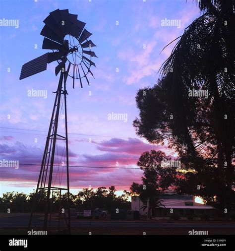 Windmill at sunset in the Australian outback Stock Photo - Alamy