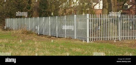 Galvanised steel palisade fence panels around paddock Stock Photo - Alamy