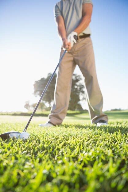 Premium Photo | Golfer about to hit golf ball