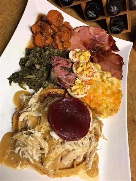 A truly southern Thanksgiving plate!! Country ham, candied yams, deviled eggs, turnip greens ...