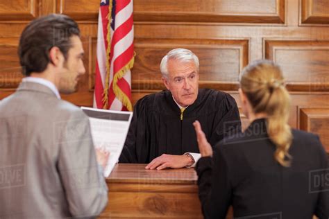 Lawyers pleading case to judge in court - Stock Photo - Dissolve