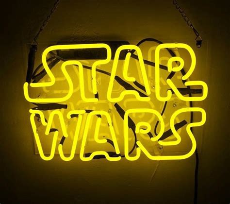 a neon sign that says star wars on it