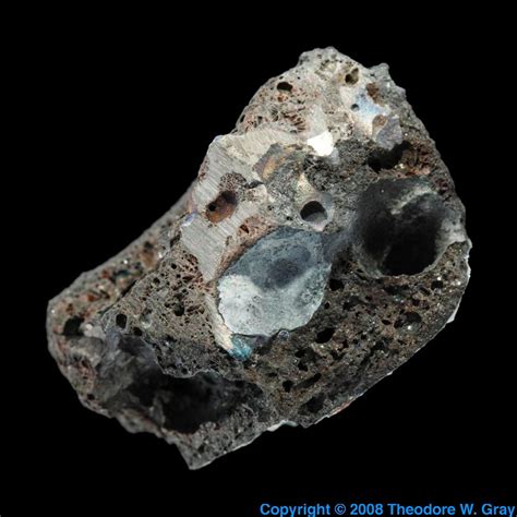 Rough titanium metal in slag, a sample of the element Titanium in the Periodic Table