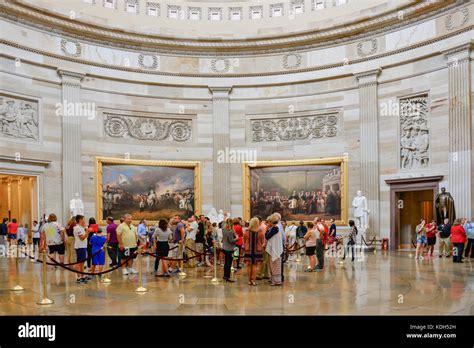 A crowd of people visiting the US Capitol Rotunda, admire the huge ...