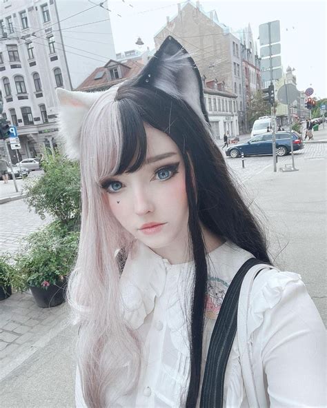 a woman with long black hair and cat ears on her head