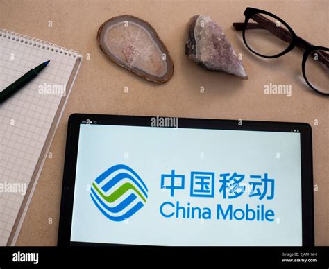 In this photo illustration China Mobile Limited logo seen displayed on a tablet Stock Photo - Alamy