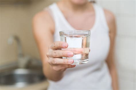 hand holding glass of water - Wyoming Department of Health