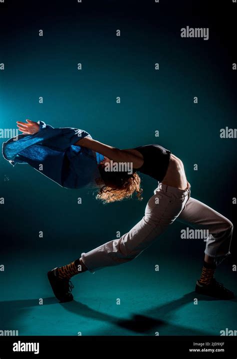 Flexible young dancer performing a stylish dance movement Stock Photo - Alamy