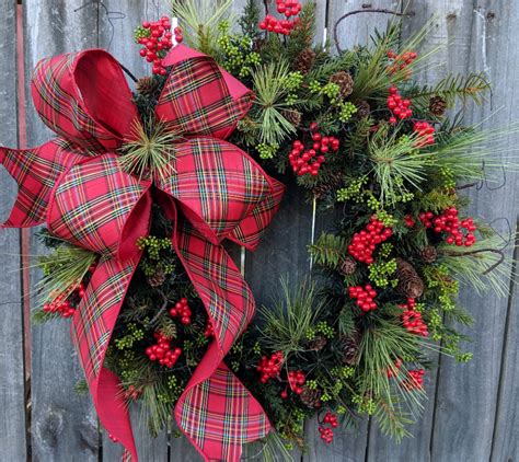 In this Christmas wreath, a rich wired plaid ribbon with a gold detail ...