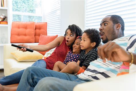 African American Family Watching Television Together Stock Photo - Download Image Now - iStock