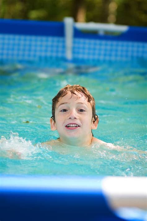 Young Boy Swimming in an Outdoor Pool Stock Photo - Image of face ...