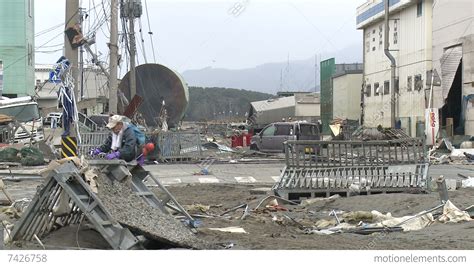 Japan Tsunami Aftermath - Man Walks Through Destroyed Port Stock video ...