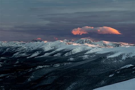 A view of a snowy mountain range at night photo – Sky with moon Image on Unsplash