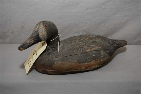 Antique hand carved wooden duck decoy with inset eyes, 14" in length and initial G.H on underside