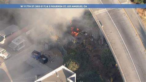 Firefighters extinguish another fire underneath another Los Angeles freeway