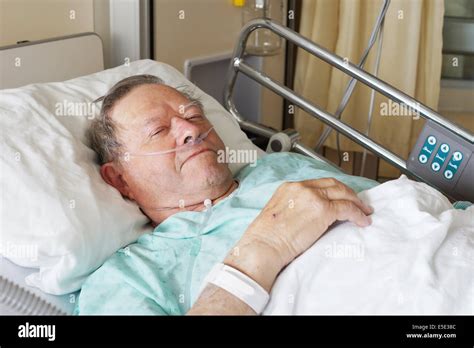 Portrait of sick old man in hospital bed Stock Photo - Alamy