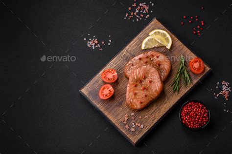 Two baked slices of tuna fillet with spices and herbs Stock Photo by ...