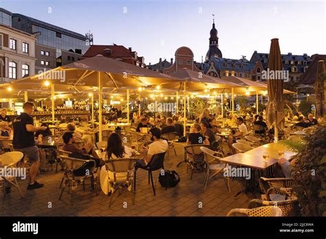 Riga nightlife; people drinking in bars and cafes at night, Riga Old ...