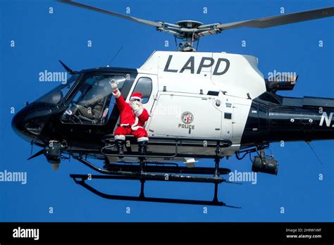 Los Angeles, California, USA. 8th Dec, 2021. Santa Claus waves from a LAPD helicopter to ...