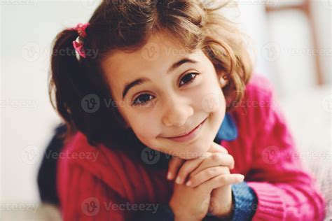 Adorable little girl with sweet smile lying down on bed. 4521025 Stock ...