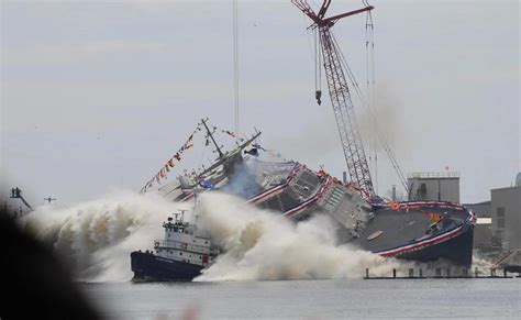 USS Cleveland (LCS-31) collides with a tugboat during side launch on ...