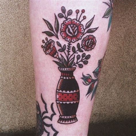 Traditional vase with flowers tattoo on the calf | Traditional tattoo ...