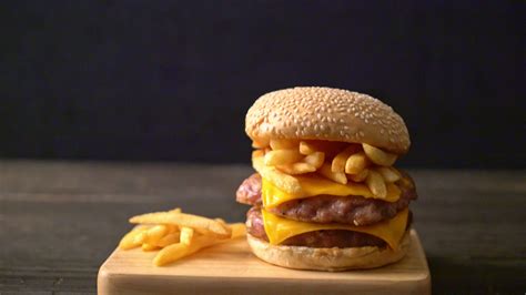 pork hamburger or pork burger with cheese, bacon and french fries ...