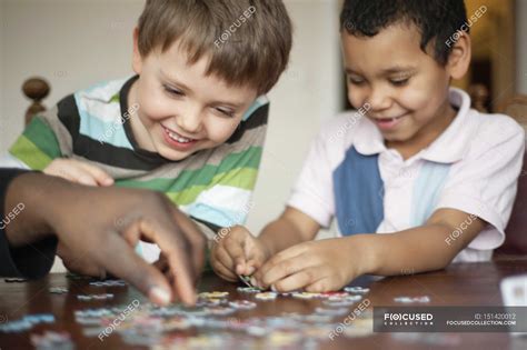 Happy boys playing jigsaw puzzle — headshot, playful - Stock Photo ...