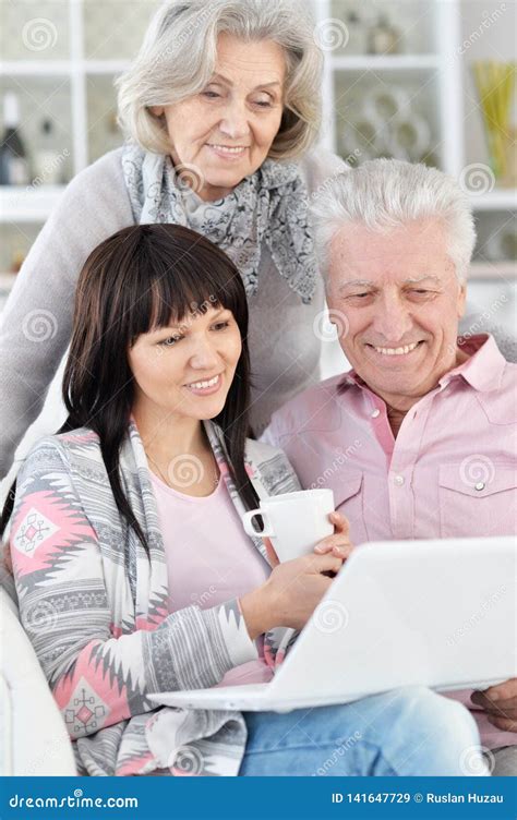 Portrait of Happy Family with Laptop Posing at Home Stock Image - Image of laptop, happy: 141647729