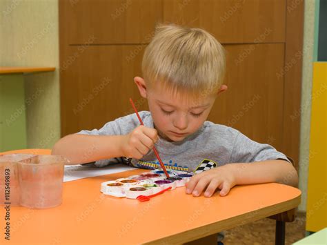 Child with Down syndrome is drawing Stock Photo | Adobe Stock