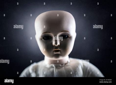 Creepy doll face on dark background Stock Photo - Alamy