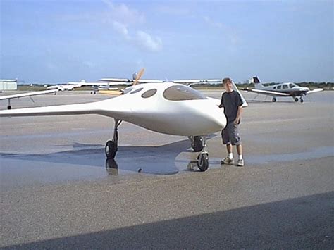 a man standing next to an airplane on the tarmac