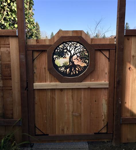 Custom gate with inset metal panel. The homeowner's decorative metal wall art was used as a ...