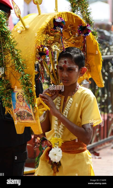 A boy carries a Kavadi during the Hindu festival of Thaipusam at Batu ...