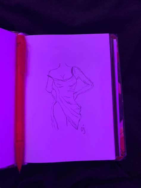 an open notebook with a drawing of a woman's torso