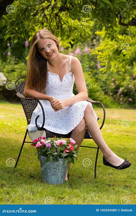 Young Woman Sitting in Garden with Flowers Stock Image - Image of bunch, happy: 105559589